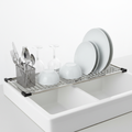 Over-the-sink expandable stainless steel dish drying rack with dishes and utensils