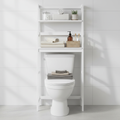Over-the-toilet freestanding ladder shelf with towels and toiletries in white bathroom