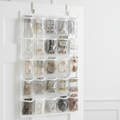 Over-the-door jewelry organizer with clear pockets holding necklaces, earrings and accessories